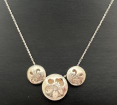 A silver 3 circular sliding bead necklace with floral pierced work designs to each. 16" fine belcher