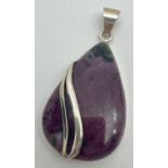 A silver teardrop shaped pendant set with ruby Zoisite with simple twist design overlay. Silver mark