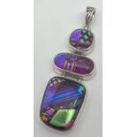 A large silver and foil art glass pendant with pierced work bale. Pendant set with 3 pieces of