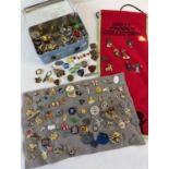 A large collection of pin badges, lapel badges and stick pins. To include Robertson's Golly, Prefect