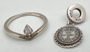 A silver Pandora ring and charm, both stamped 'S 925 ALE'. A clear stone set wishbone style ring