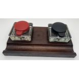 An Art Deco dark oak standish desk stand with double glass inkwells. Square shaped clear glass