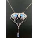 A silver Art Nouveau style fixed pendant necklace. A floral design central pendant with triangular
