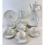 A vintage porcelain coffee set by Thomas Rosenthal in Blue Rose design with 24k white gold trim.