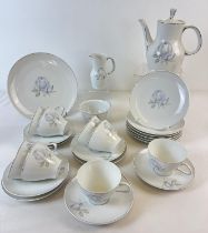 A vintage porcelain coffee set by Thomas Rosenthal in Blue Rose design with 24k white gold trim.