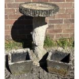 A large weathered garden bird bath in the form of a tree trunk together with a small pair of