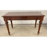 A Victorian dark wood 2 drawer hall/console table with decorative carved legs and raised on