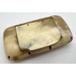 An antique horn rectangular shaped snuff box containing a small amount of snuff. Approx. 8 x 4.5cm.