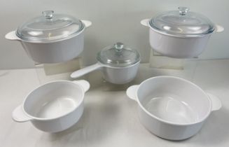 A collection of French Corning kitchen ware. Comprising: 2 lidded casserole dishes, a large