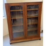 An Art Deco dark oak 2 door, glass fronted bookcase with channelled detail, complete with key. 4