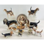 A collection of assorted ceramic & resign ornaments of beagles and bassett hounds. To include