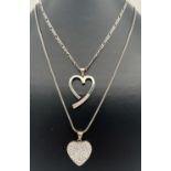 2 heart shaped silver pendant necklaces. An open heart pendant set with 11 round cut crystals on a