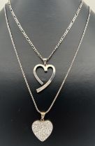 2 heart shaped silver pendant necklaces. An open heart pendant set with 11 round cut crystals on a