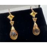 A pair of 10k yellow gold, citrine set drop earrings with leverback hooks. Each earring set with a