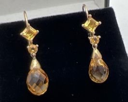 A pair of 10k yellow gold, citrine set drop earrings with leverback hooks. Each earring set with a