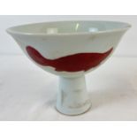 A white glazed Chinese stemmed bowl with red hand painted turtle design to outer bowl. Signature