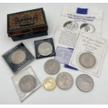 A small collection of British coins and commemorative crowns together with a small vintage cash tin.