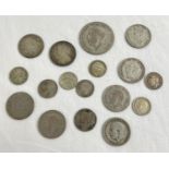 A collection of vintage and antique coins to include silver examples. Lot includes a George V half