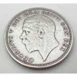A .500 silver 1931 George V crown with crown and wreath detail to reverse.