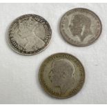3 antique florin coins. A Queen Victoria Gothic silver florin together with 2 George V Florins -