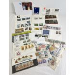A collection of assorted Mint stamp presentation packs, first day covers and loose stamps. First day