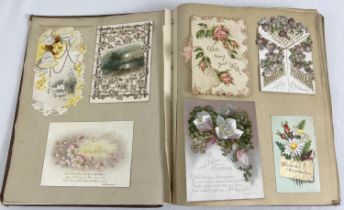 A vintage album of assorted Victorian & Edwardian greeting cards (stuck in).