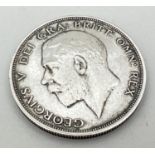 A 1911 George V silver half crown coin with crown and coat of arms to reverse.