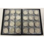 A folder containing 72 assorted white metal coins from around the world. Folder approx. 21cm x 15cm.