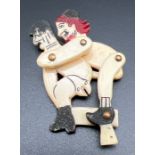 A carved bone nude erotic articulated figure, sprung to reverse. With coloured detail. Approx. 5cm
