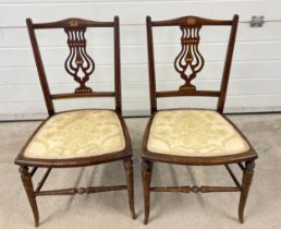 A pair of decorative Edwardian bedroom chairs with inlaid detail to backs and turned front legs.