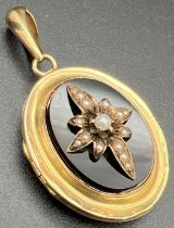 An antique Victorian 24ct gold locket set with onyx panels back & front and ornate seed pearl centre