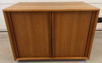 A mid century teak low cupboard with sliding doors and interior shelf. Approx. 72cm tall x 92cm