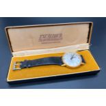 A vintage Excalibur men's wristwatch with black leather strap, gold plated case, brushed pale silver