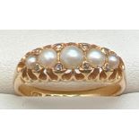 An antique Edwardian 18ct gold, pearl and diamond ring. Set with 5 graduated white pearls and 8