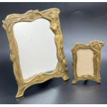 A brass Art Nouveau style mirror and matching small photo frame, with female figural and floral