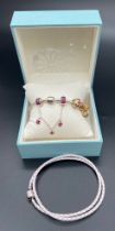 A boxed silver Ownory charm bracelet with enameled and stone set charms from the Benjarong