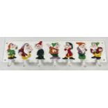 A cast iron set of wall hooks with painted Disney 7 Dwarves decoration. Approx. 59cm long.