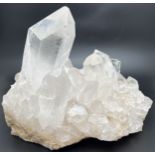 A large heavy clear quartz cluster with natural and rainbow inclusions. Approx. 33cm x 22cm. Total