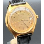 A classic style men's electronic wristwatch by Longines with black leather strap. Gold tone case and