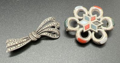 2 vintage stone set brooches. A silver bow brooch set with marcasite stones and a white metal brooch