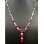 A silver ruby and white topaz fixed drop pendant necklace with spring ring clasp, by The Genuine Gem