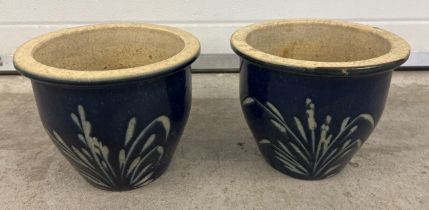 A pair of dark blue glazed garden pots with foliate design, approx. 22cm tall x 26cm diameter.