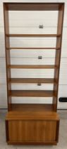 A mid century G Plan wall unit with sliding door cupboard to base and 5 shelves. 3 fixed shelves and