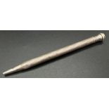 A vintage sterling silver propelling pencil with engine turned decoration to main body. Approx.
