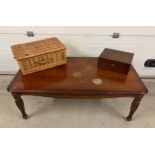 A large modern coffee table together with a vintage mahogany writing box and a picnic basket.