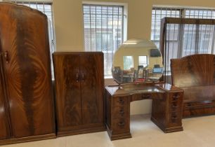 A vintage 1940's walnut veneer 4 piece bedroom suite with shaped handles of channelled design. 2