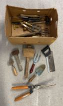 A box of assorted vintage & modern hand tools, mostly garden tools.