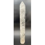 A large polished clear quartz tower wand. Natural galaxy formations throughout with small areas of