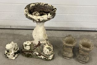 A collection of vintage concrete garden ornaments and pots. A bird bath with fish design to base (