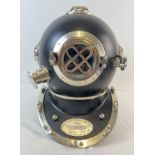 A full sized replica black coloured metal mark V US Navy divers helmet. With glass panels and hinged